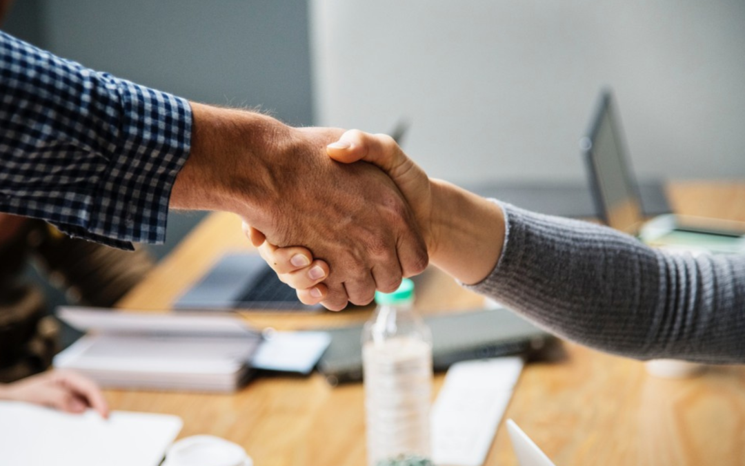 Business owner handing over keys to the new owner, symbolizing successful business transition